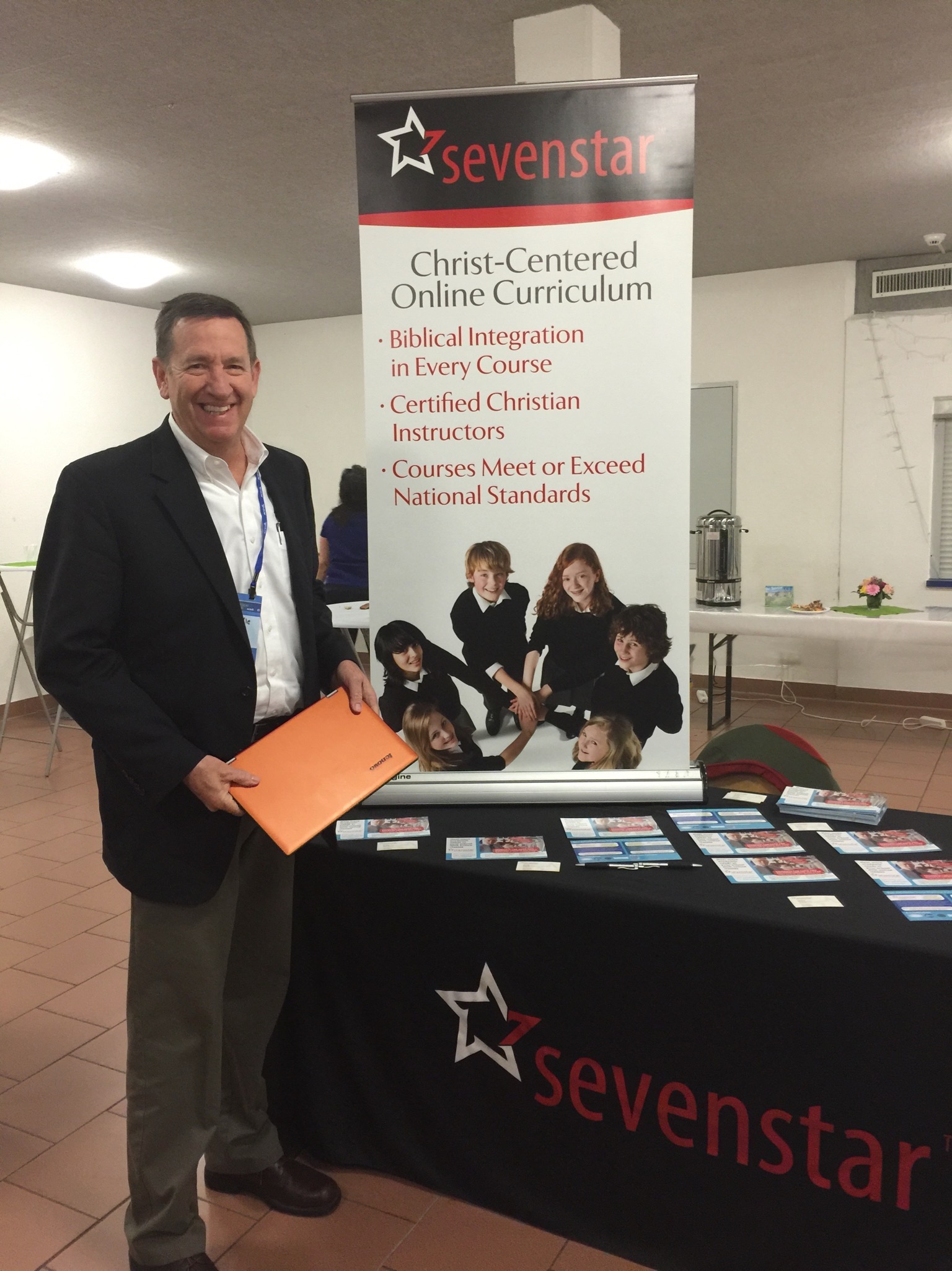 Sevenstar founder standing at booth promoting Sevenstar.