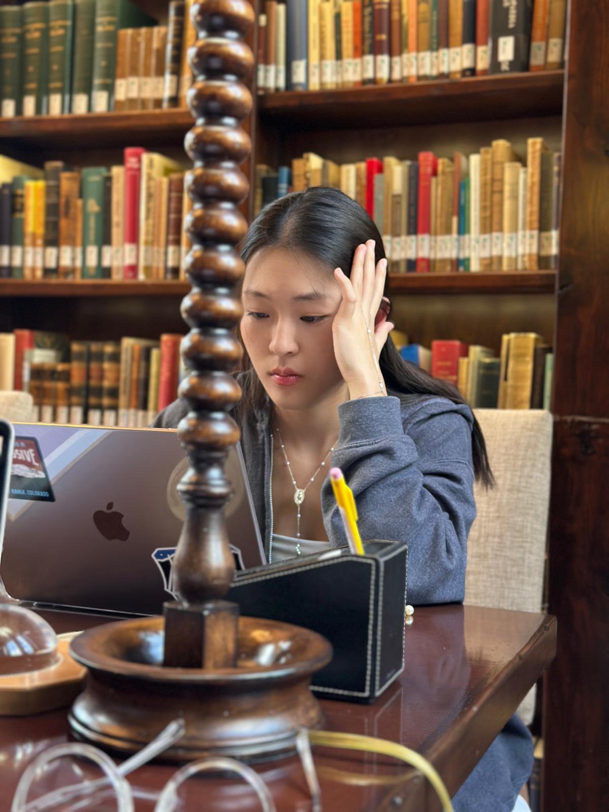 student sitting in library learning