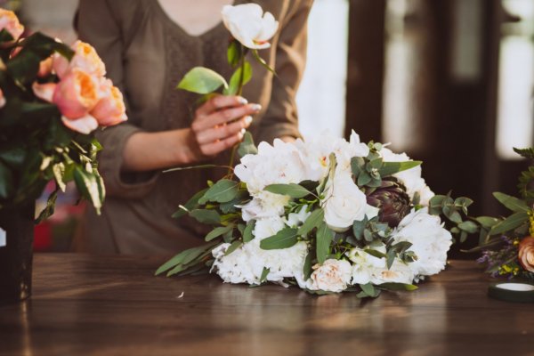 women holding rose and setting it on table in remembrance of someone